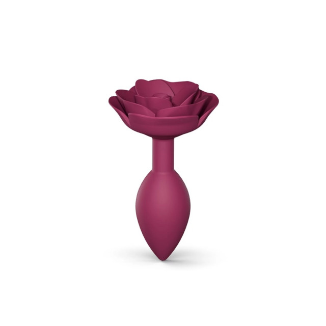 Plug anal en silicone souple avec une butée en forme de rose qui habille l'anus